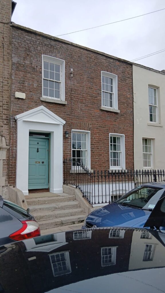 UEH Ireland team applying protective ProPERLA finish during a wall cleaning and coating in Dublin on a historic Georgian house.